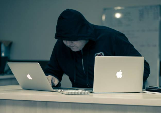 A person using a laptop in a private setting to represent anonymous web surfing and digital privacy