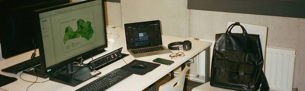 A modern workspace with a person using a laptop, representing research and learning about proxies