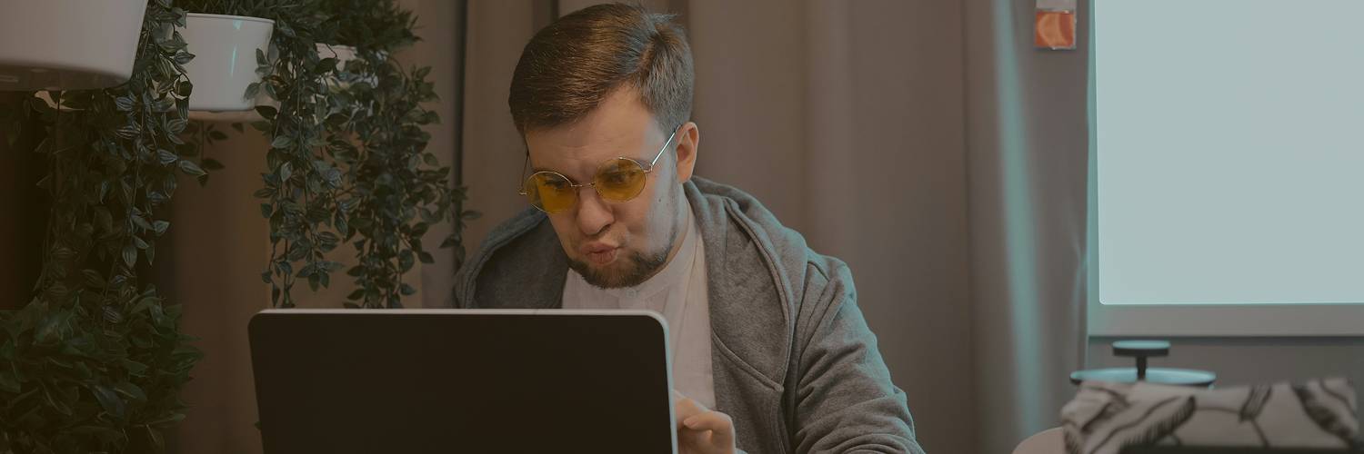 Person comparing VPN and proxy privacy on laptop at modern desk